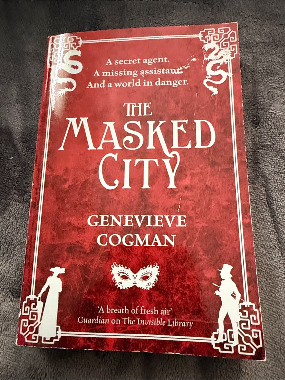The Masked City by Genevieve Cogman - Red Paperback